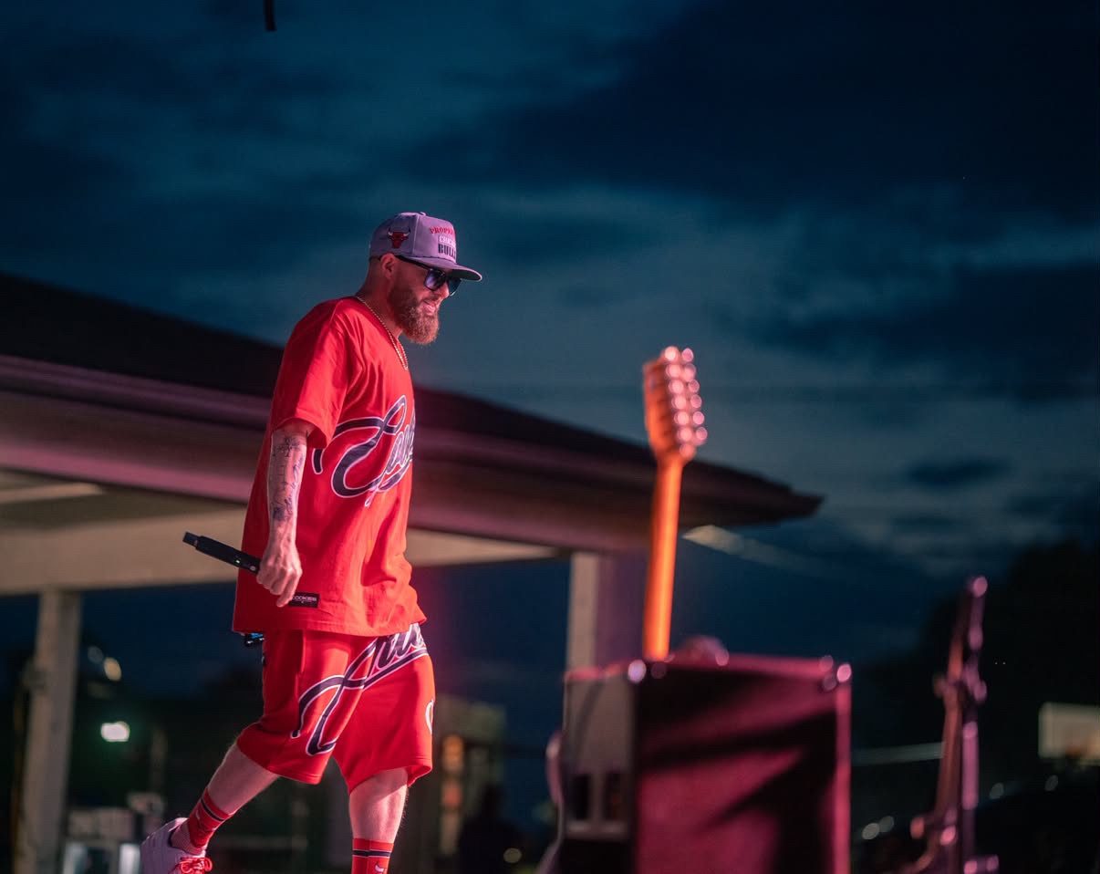 Q Bosilini performing at dusk